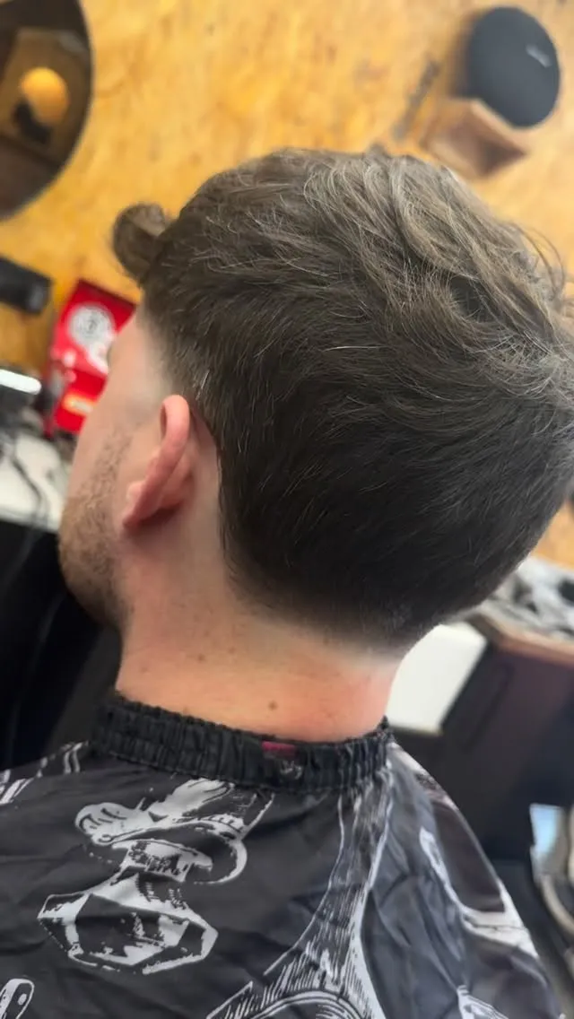 A textured crop and beard, side profile
