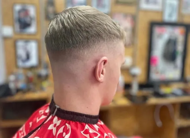 A blonde crop with a clean skin fade