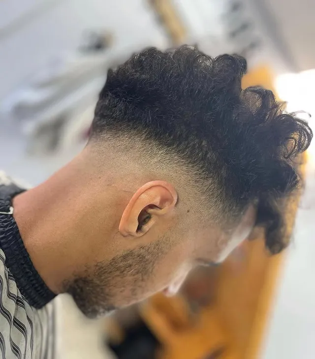 A curly top with a drop fade