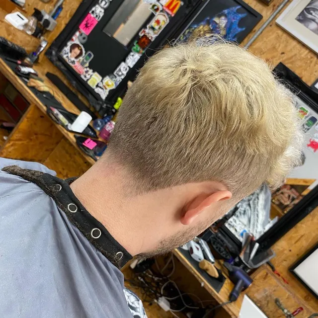 A blonde crop being finished in the chair