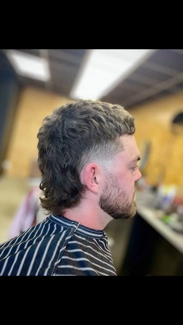 A modern mullet with a faded back and beard