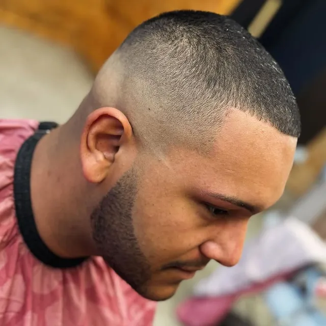 A close skin fade blended into a beard line