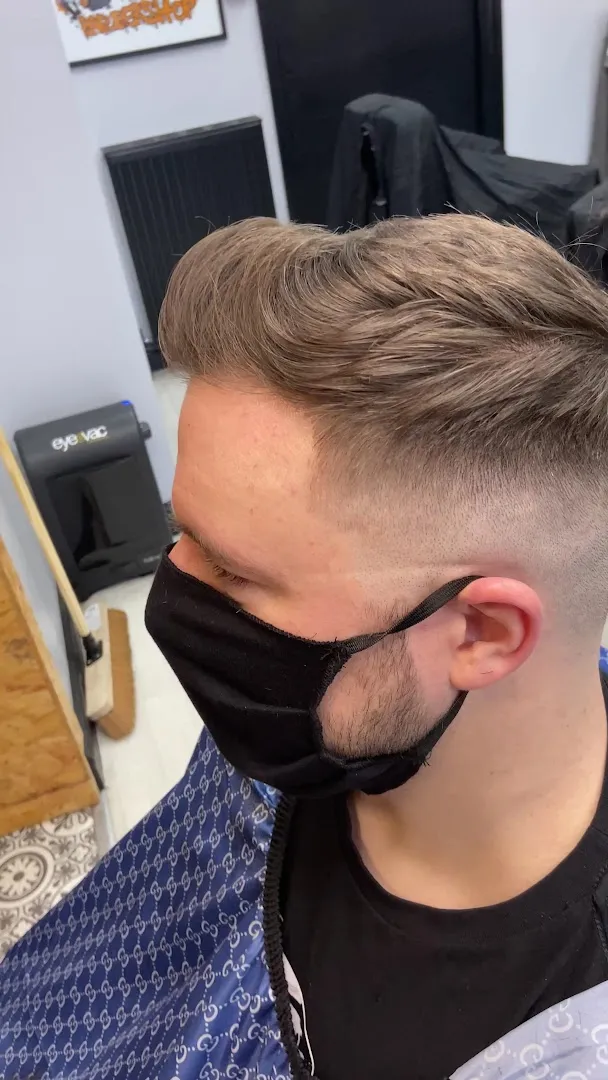 A textured quiff over a skin fade